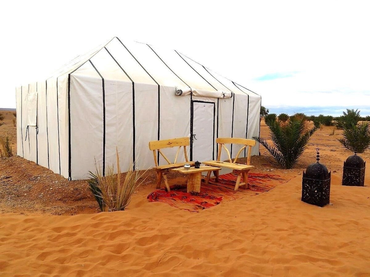 The tents of Sundrift Luxury Camp beneath the Erg Chebbi dunes