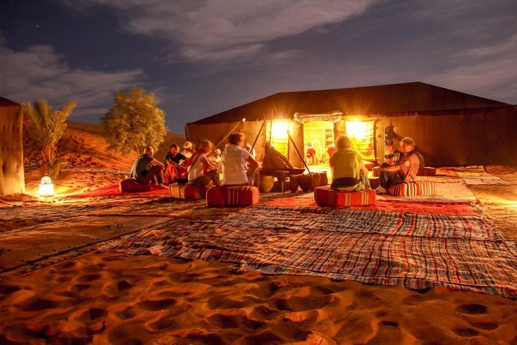Lantern-lit path through Sundrift Luxury Camp at dusk
